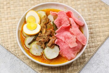 Lontong Sayur Padang is a typical Indonesian food, lontong is served with jackfruit curry and red crackers
