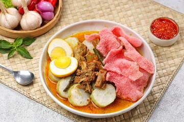 Lontong Sayur Padang is a typical Indonesian food, lontong is served with jackfruit curry and red crackers
