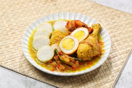 Lontong cap go meh is a Chinese Indonesian Peranakan consisting of lontong served with chicken opor, lodeh vegetables, fried liver sambal, egg, beef, koya powder, sambal, and crackers