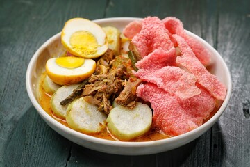 Lontong Sayur Padang is a typical Indonesian food, lontong is served with jackfruit curry and red crackers
