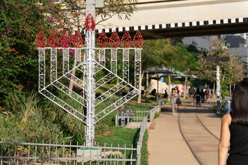 Menora model for Jewish Hanukkah outdoors on Tel Aviv street in December