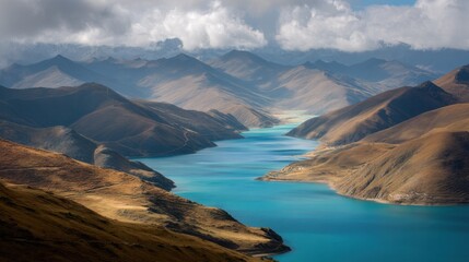 Naklejka premium A river flows through a valley surrounded by mountains in Tibet. Clouds drift above as the sun shines on the water highlighting the colors of the landscape. This scene shows the natural terrain.