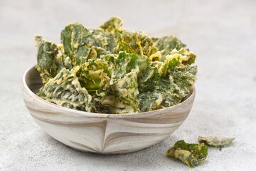 Keripik bayam. Spinach chips, made from spinach leaves fried using seasoned flour.