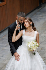 Couple shares tender moment during outdoor wedding celebration in charming location