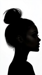 Fototapeta premium Woman's dark silhouette shows a side profile against a bright white background, focusing on her hair, eyelashes, and facial features.