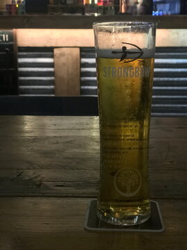 glass of Strongbow cider backlit in a bar in Skegness UK. Jan 2025