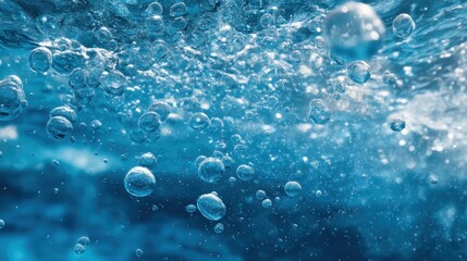 Naklejka premium Bubbles can be seen rising in clear blue water with light reflecting off the surface. The scene captures the movement and energy of the underwater environment.