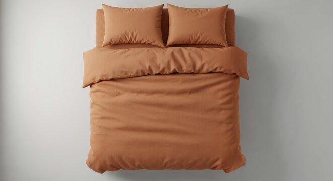 A neatly arranged bed features a textured terracotta duvet cover and two matching pillows, presented from a top-down view on a clean light grey background.