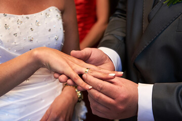 Groom Putting Wedding Ring on Bride&rsquo;s Finger