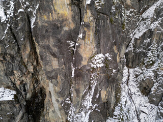 Snowy Cliff Faces in British Columbia: Rugged Granite Walls and Winter Forest Scene