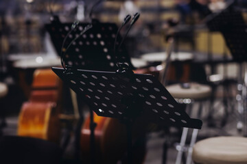 Concert view of contrabass violoncello player with vocalist and musical band during string concert, jazz orchestra performing music, violoncellist cello jazz player on stage in club, music arena hall
