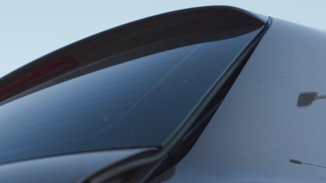 Car trunk power liftgate closing, close up of electric strut mechanism with smooth hydraulic motion and clean mechanical sound