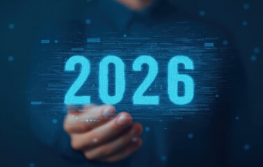 Businessman's hand showing a glowing 2026 digital hologram, symbolizing future digital technology, innovation, and business planning