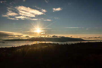 Aerial sunset view of a beautiful sunset behind Orcas Island, Washington. Orcas Island is the largest of the San Juan Islands of the Pacific Northwest, in northwestern Washington, United States.