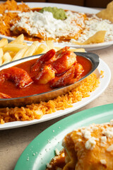 A view of a plate of camarones a la diabla, among other Mexican entrees.