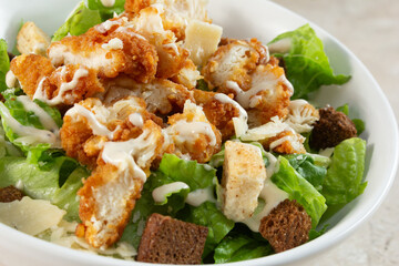 A closeup view of a chicken Caesar salad.