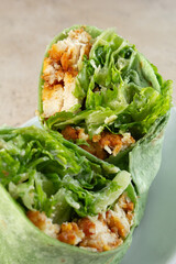 A view of a chicken Caesar wrap.