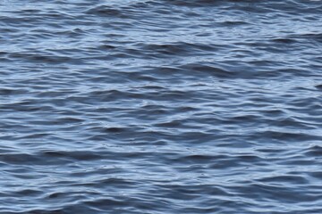 Natural ripples on blue water surface texture