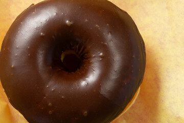 A top down view of a chocolate covered raised donut.