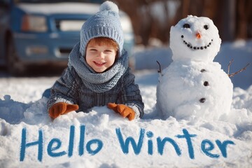 little child with a snowman with the words Hello Winter written in the snow beside them.