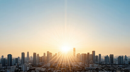 Hazy golden skyline glow sunrise over modern city skyline with sunburst