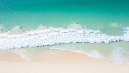Aerial view of a gentle ocean wave on a sandy beach.