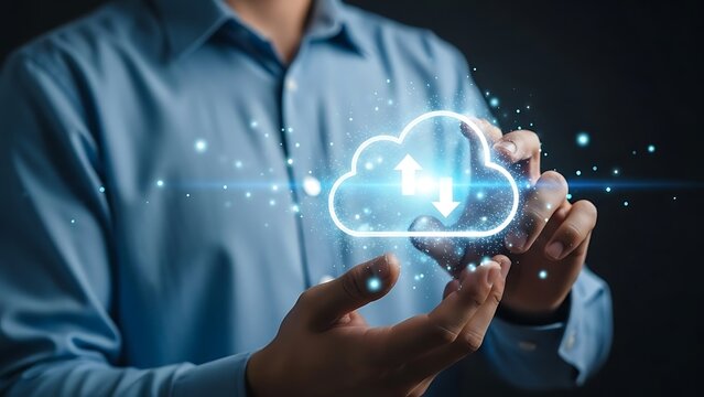 Businessman holding a glowing cloud computing icon for digital data storage and transfer. - Powered by Adobe