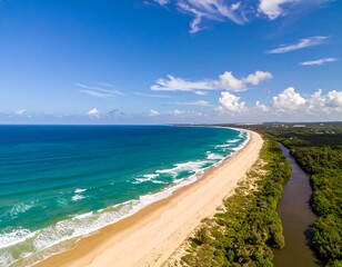 Aerial view of a stunning beach meeting the ocean under a blue sky