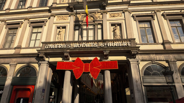 BRUSSELS, BELGIUM - NOVEMBER 26, 2025 - Galeries Royales Saint Hubert facade revealing elegant architecture and holiday adornment