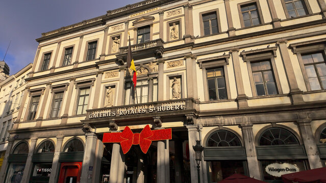 BRUSSELS, BELGIUM - NOVEMBER 26, 2025 - Historic Galeries Royales Saint Hubert facade with Christmas bow in Brussels, Belgium