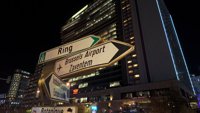 BRUSSELS, BELGIUM - NOVEMBER 26, 2025 - Illuminated street signs directing traffic towards Brussels Airport Zaventem at night