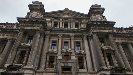 Naklejka premium BRUSSELS, BELGIUM - NOVEMBER 26, 2025 - Ornate facade of the Palace of Justice in Brussels, Belgium, under a cloudy sky