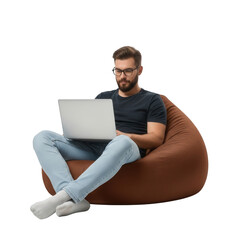 Man in glasses using laptop while sitting on a bean bag chair isolated on transparent background