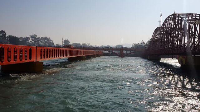 Bridges Ganga river in Haridwar Kumbh mela. Ganga water is used by hindu pilgrimage in Dehradun Uttarakhand. Water is blue and flows very fast.