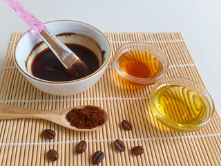 Natural coffee face mask. Coffee face mask homemade. Ingredients for natural coffee mask and scrub, with honey and olive oil. Copy space for your text.