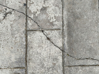 cracks on a cement surface, shown from the top, alongside closeup details.