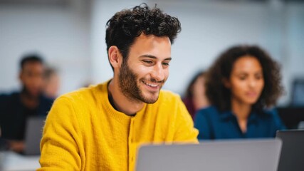 Modern office business work space with young male adult worker using laptop open plan setting, diverse team background, natural light, clean desk, calm productivity, collaboration, creative energy - Powered by Adobe