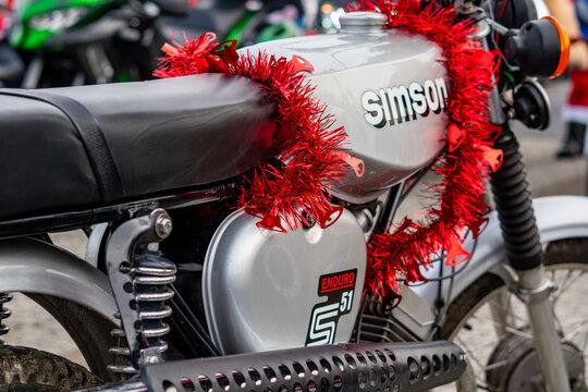 Festively decorated Simson S51 motorcycle at a Saint Nicholas event in a cheerful winter outdoor setting