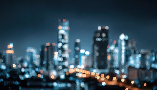 Blurry night cityscape with illuminated skyscrapers and streetlights