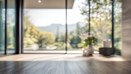 Bright sunlit room with large windows overlooking lush green landscape