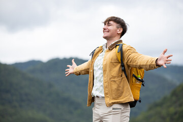 Man breathing deeply and embracing nature on eco trip
