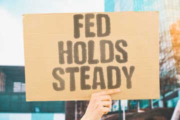 "Fed Holds Steady" Central bank maintains current rates. FED. HOLDS. STEADY. CENTRAL. RATES.