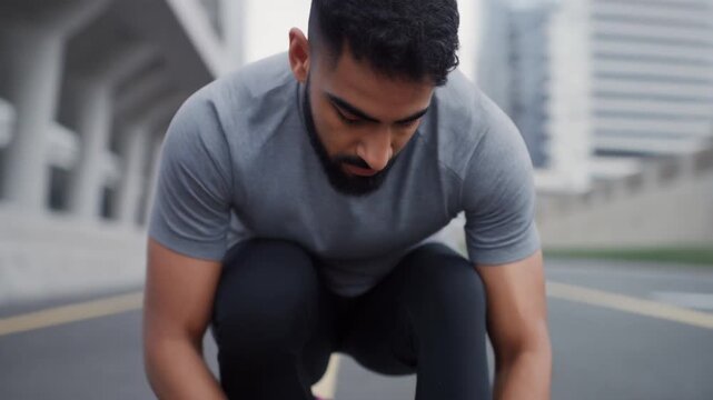 Fitness man tying shoelaces before a run, urban environment, motivation, 4k