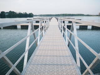 Peaceful Walkway Over Water Towards Distant Shoreline View