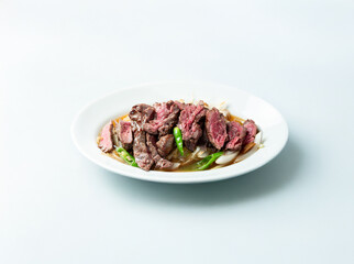 Meat tataki with vegetables on a plate