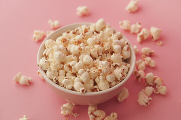 Popcorn in a bowl on a pink background during snack time