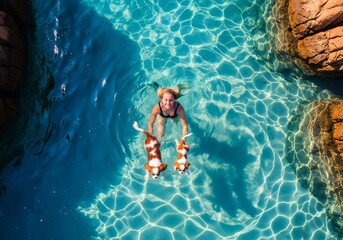 Young woman snorkeling in crystal clear blue water, enjoying a refreshing swim on a sunny day.
