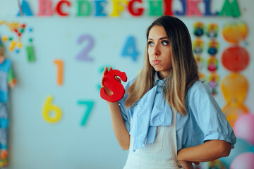 
Worried Speech Therapist Holds the Letter S
Specialist aims to correct sigmatism in speaking in little patients 

