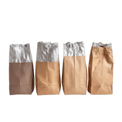 Four paper bags with metallic interiors stand in a line