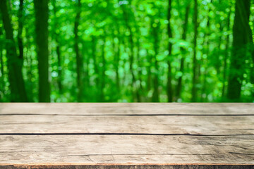 wooden table with forest bokeh background